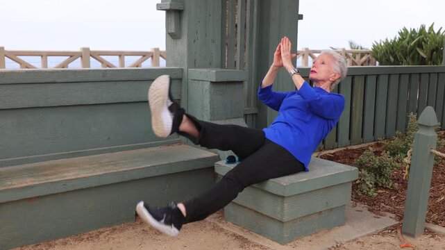 Senior woman gets her morning exercise at a park overlooking the Santa Monica beach.