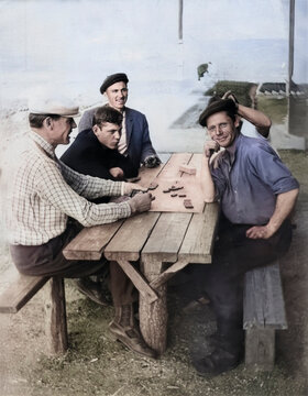 Lozova, Ukrainian SSR, USSR - March 21, 1974: retro vintage photo of men playing dominoes outdoors