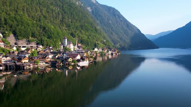 Drone View of Picturesque Lakeside Town Hallstatt with Layered Alp Mountains towering above. Warm Summer Morning. Salzkammergut, Austria UNESCO heritage site