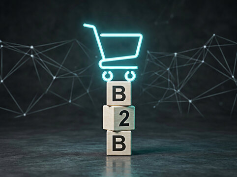 Glowing neon shopping cart icon balanced carefully on wooden blocks spelling out the term b2b business