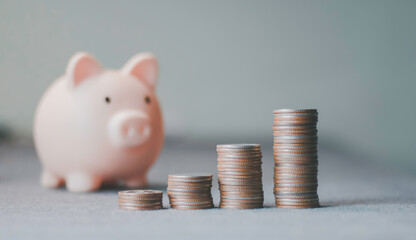 Piggy bank, stacked coins representing financial savings, investment growth, wealth accumulation, budgeting, retirement planning, economic stability, passive income, money management. © Krittamet