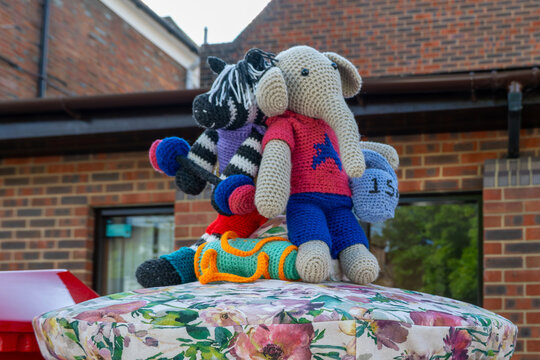 Emsworth England - May 3 2026: knitted post box topper zebra and elephant wearing sports gear