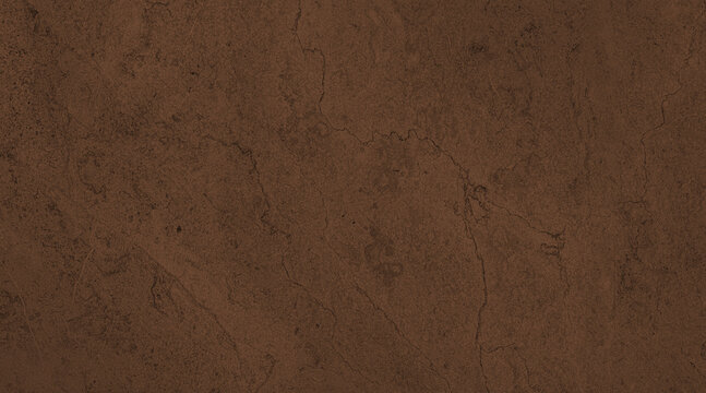 A close-up of a dark, textured surface with subtle patterns, resembling raw earth or aged material