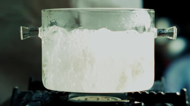 Cook Dropping Raw Ravioli Into Boiling Water. Italian Pasta 