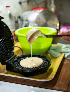 The hostess prepares the cakes heart waffle,old-fashioned way, using traditional European cuisine and utensils.