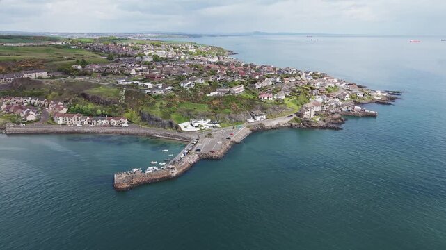 Aerial view of Pettycur coastal village houses and scenic rocky shoreline, Fife, Scotland