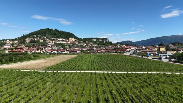 Drone footage of the historic parish church tower and clock tower in Cavaion Veronese near Lake Garda