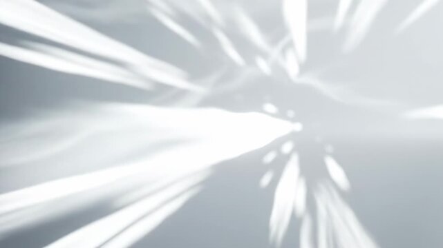 A luminous, ethereal burst of bright light streaks across a soft, hazy grey void, evoking a sense of rapid motion and the beginning of a cosmic event, creating an abstract visual of pure energy