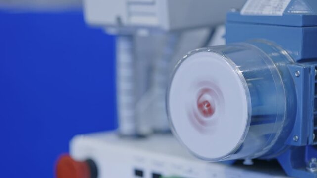 Close up of high speed laboratory centrifuge operating in modern biotechnology facility. Advanced medical equipment used for sample separation and clinical research analysis.