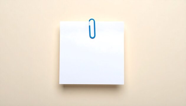 Reminder note with blue paperclip on light cream background for office stationery, planning and memo concept