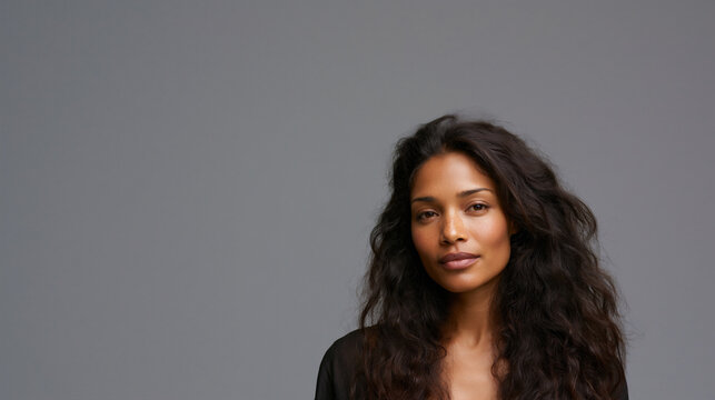 beautiful afro asian woman portrait with long hair and dark skin, elegant afro asian female studio headshot beauty portrait, confident multicultural woman beauty fashion studio closeup portrait