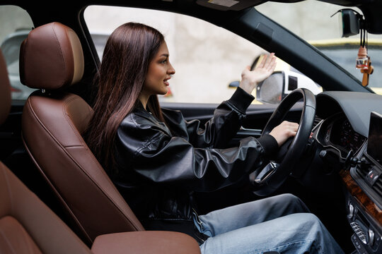 Beautiful woman beep in the car in panic with closed eyes while driving on high speed.