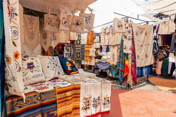 Fototapeta premium Otavalo Market Ponchos Plaza with Colorful Indigenous Textiles and Crafts, Ecuador