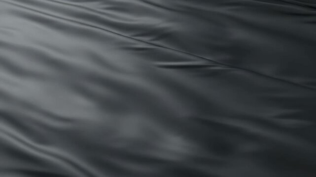 Dark gray fabric texture with smooth folds and creases flowing motion abstract background