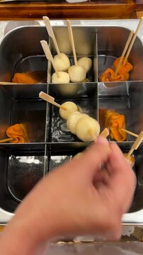 Odeng, a Korean fish ball soup snack, is delicious, warm, spicy, and savory.