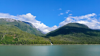 Fototapeta premium Misty Fjords, Alaska - USA - August 27, 2024 - Coastal Mountains and Waterfall