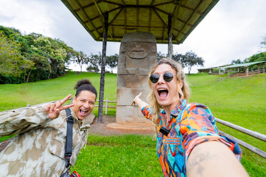 Tourists taking selfie at San Agustin stone monument