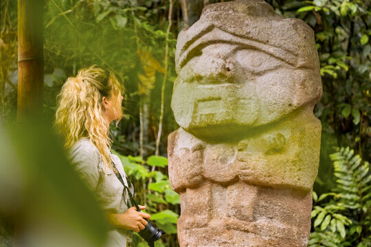 Traveler viewing stone statue in San Agustin Park