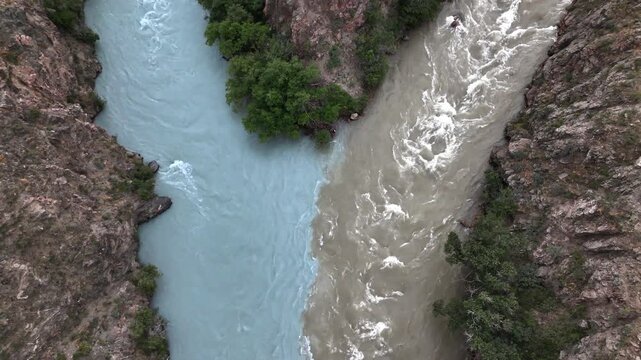 Aerial of turquoise and brown rivers meeting at Chu-Kemin confluence, Boom Gorge, Kyrgyzstan
