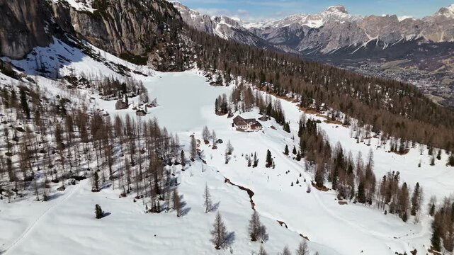 Drone reveal of snowy Lago Federa and Rifugio Croda da Lago with Becco di Mezzod&Atilde;&not;, Dolomites