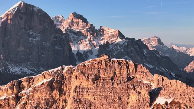 Drone panorama of Tofana di Rozes at sunset with Nuvolau ridge and Nuvolao Hut in foreground, Dolomites