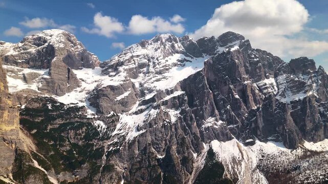 Drone parallax past Torre Trieste spire revealing Civetta north face behind, Dolomites