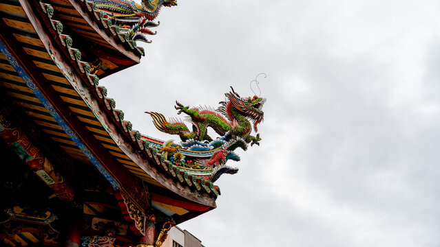 Intricate dragon sculpture at Longshan Temple in Taipei