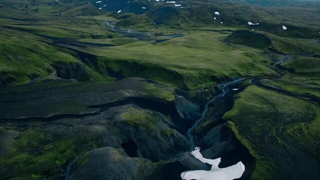 Expansive Icelandic Highlands with Rivers and Snow Patches from Above
