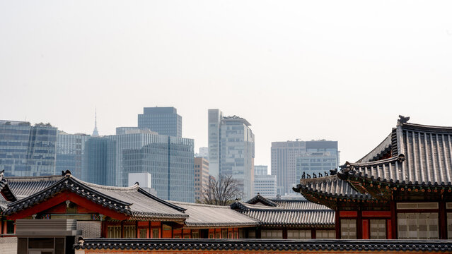 Modern skyline contrasting with historic Korean palace