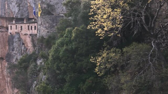 Vertical cliff face revealing embedded monastery in rock, Tzoumerka mountains, Greece