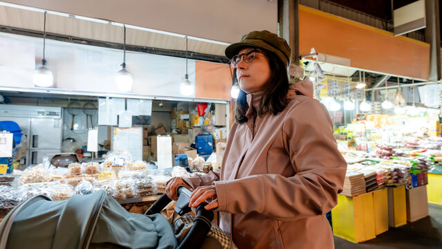 Mother with stroller at Gwangjang Market, Seoul, South Korea