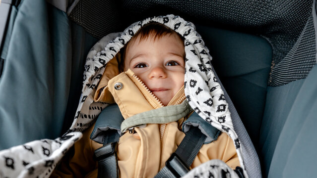Cozy baby in stroller during outdoor stroll in warm blanket