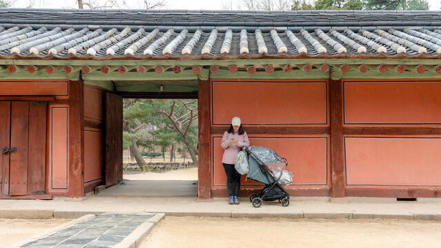 Family travel moment at Jongmyo Shrine gate in Seoul