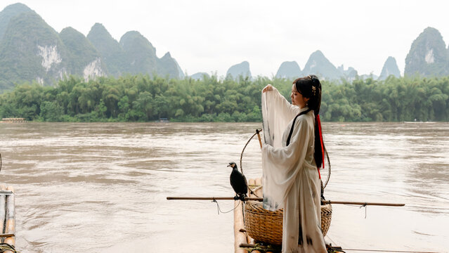 Hanfu girl with cormorant on Li River in Xingping, China