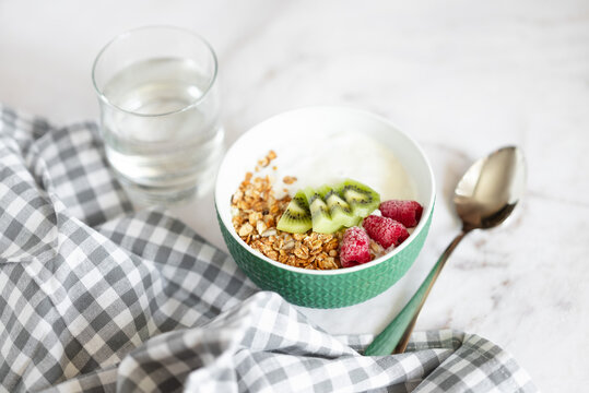 Healthy yogurt bowl with kiwi raspberry and granola oatmeal