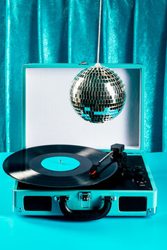Retro vinyl record player with disco ball on blue set