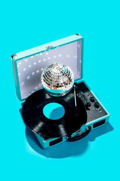 Portable record player with vinyl and disco ball