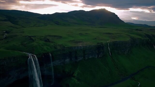Breathtaking aerial views of a cascading waterfall and surrounding cliffs