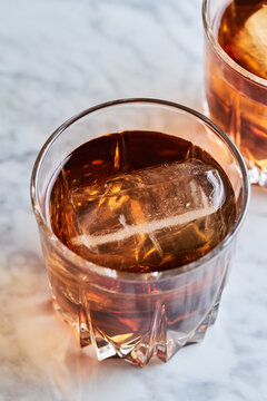 Close up bourbon whisky on ice in a crystal tumbler glass