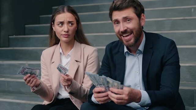 Financial discrimination Caucasian business rich man sad woman little salary outdoor in city inequality money injustice male guy happy businessman smiling blink upset girl female businesswoman dollars