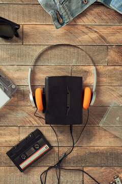 Retro walkman with orange headphones and cassette flat lay