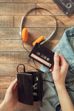 Retro walkman with cassette and bright orange headphones