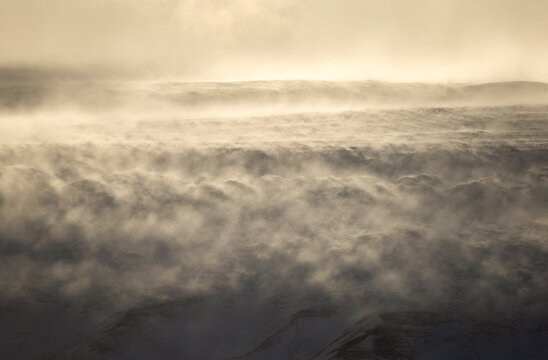 Winter fog drifting over snowfield in Iceland highland