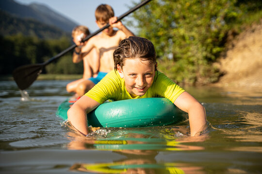 Children playing water games at the lake on vacation