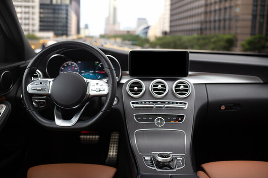 Modern car interior with city skyline seen through windshield