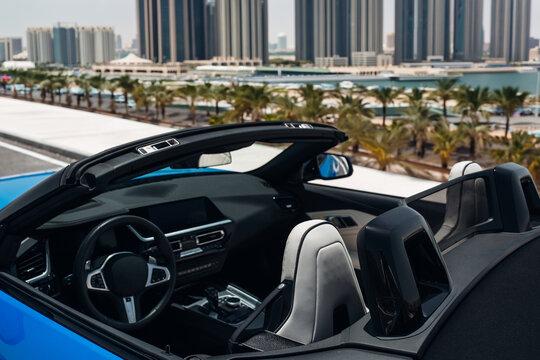 Luxury convertible car interior with Dubai Marina skyline