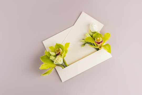 Minimal floral envelope with blank card on pastel background