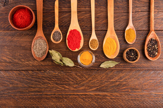 Assortment of spices and seeds on wooden table background