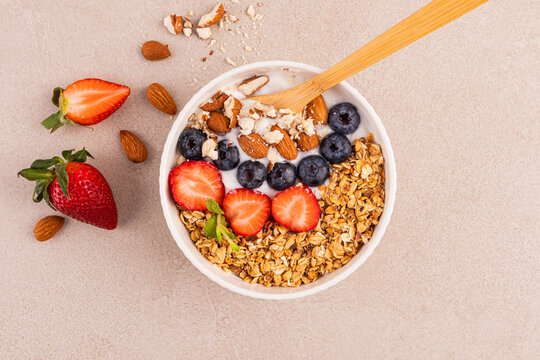 Healthy breakfast bowl with granola, fruit and nuts