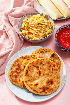 Traditional Salvadoran pupusas with curtido and sides